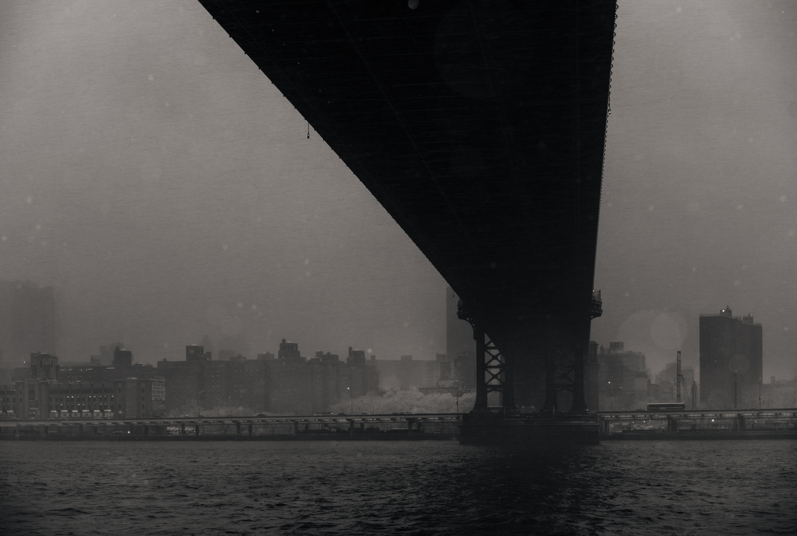 Foggy bridge near a river