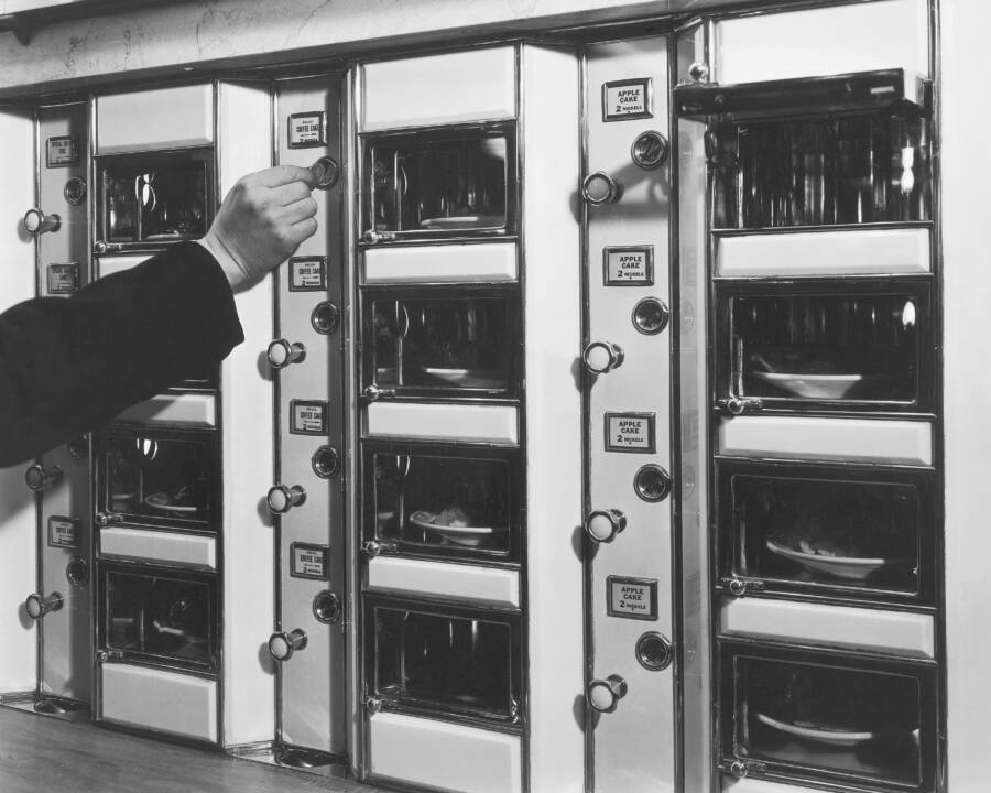 man-places-coin-in-automat